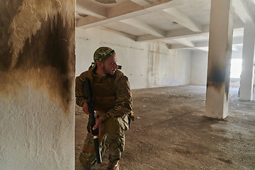 Image showing A group of professional soldiers bravely executes a dangerous rescue mission, surrounded by fire in a perilous building.