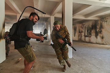 Image showing A professional cameraman captures the intense moments as a group of skilled soldiers embarks on a dangerous mission inside an abandoned building, their actions filled with suspense and bravery