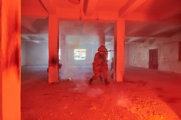 Image showing A group of professional soldiers bravely executes a dangerous rescue mission, surrounded by fire in a perilous building.