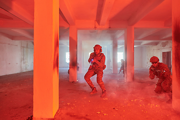 Image showing A group of professional soldiers bravely executes a dangerous rescue mission, surrounded by fire in a perilous building.