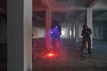 Image showing A group of professional soldiers bravely executes a dangerous rescue mission, surrounded by fire in a perilous building.