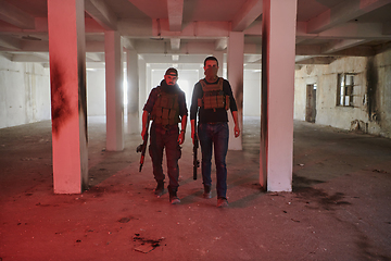 Image showing An abandoned building serves as the stronghold for a team of terrorists, fiercely guarding their occupied territory with guns and military equipment