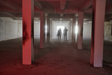 Image showing An abandoned building serves as the stronghold for a team of terrorists, fiercely guarding their occupied territory with guns and military equipment