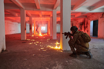 Image showing A group of professional soldiers bravely executes a dangerous rescue mission, surrounded by fire in a perilous building.