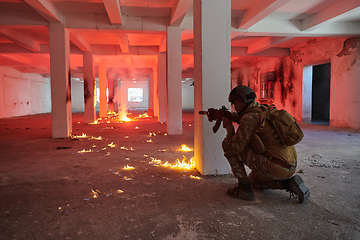 Image showing A group of professional soldiers bravely executes a dangerous rescue mission, surrounded by fire in a perilous building.