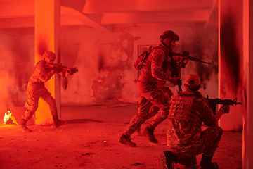 Image showing A group of professional soldiers bravely executes a dangerous rescue mission, surrounded by fire in a perilous building.