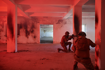 Image showing A group of professional soldiers bravely executes a dangerous rescue mission, surrounded by fire in a perilous building.