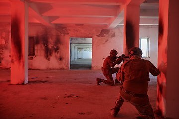 Image showing A group of professional soldiers bravely executes a dangerous rescue mission, surrounded by fire in a perilous building.