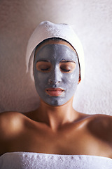 Image showing Blissful beautification. a beautiful young woman relaxing during a facial treatment at a spa.