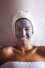 Image showing Indulging in some luxurious beauty treatments. A young woman relaxing during a facial treatment at a spa.