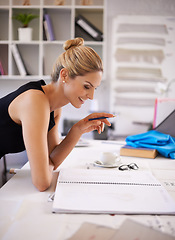 Image showing Creating a masterpiece. A fashion designer working on her sketches.