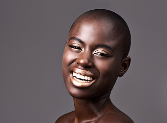 Image showing Laughter is the cheapest medicine. A beautiful woman smiling happily while standing in a studio.