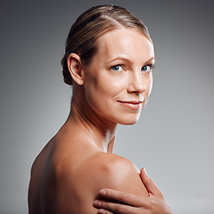 Image showing Beautiful mature woman posing in studio against a grey background