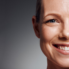 Image showing Beautiful mature woman posing in studio against a grey background