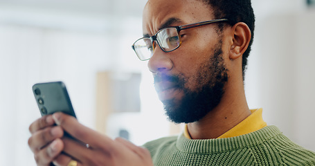 Image showing Communication, house and a black man with a phone for social media, reading chat or notification. Serious, internet and an African person with a mobile for an app, connection or search on the web