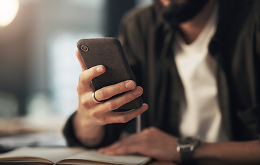 Image showing The make it hAPPen device. an unrecognisable businessman using a smartphone during a late night at work.