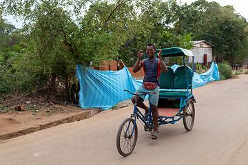 Image showing Traditional rickshaw on the city streets. Rickshaws are a common mode of transport in Madagascar.