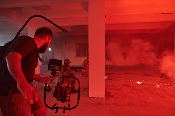 Image showing A professional cameraman captures the intense moments as a group of skilled soldiers embarks on a dangerous mission inside an abandoned building, their actions filled with suspense and bravery