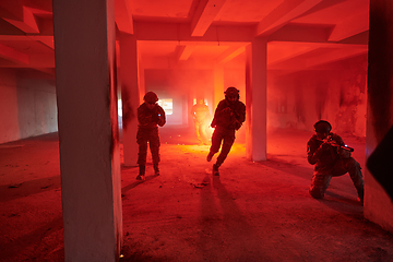 Image showing A group of professional soldiers bravely executes a dangerous rescue mission, surrounded by fire in a perilous building.