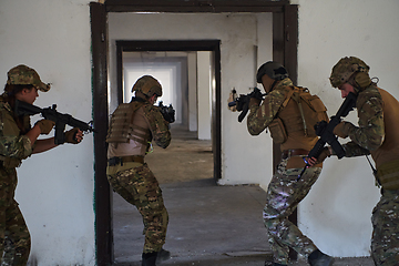 Image showing A group of professional soldiers bravely executes a dangerous rescue mission, surrounded by fire in a perilous building.