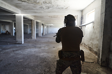 Image showing A professional soldier in an abandoned building shows courage and determination in a war campaign