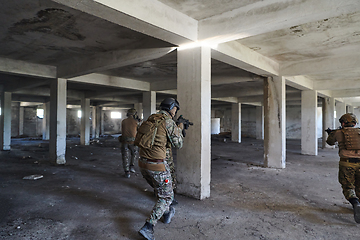 Image showing A group of professional soldiers bravely executes a dangerous rescue mission, surrounded by fire in a perilous building.