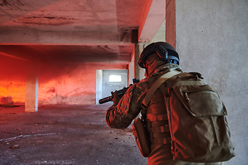 Image showing A group of professional soldiers bravely executes a dangerous rescue mission, surrounded by fire in a perilous building.