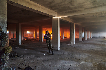 Image showing A group of professional soldiers bravely executes a dangerous rescue mission, surrounded by fire in a perilous building.