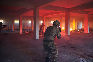 Image showing A group of professional soldiers bravely executes a dangerous rescue mission, surrounded by fire in a perilous building.