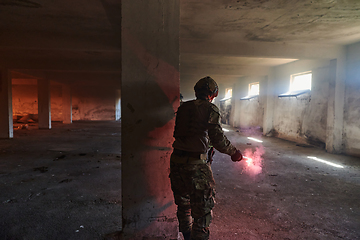 Image showing A group of professional soldiers bravely executes a dangerous rescue mission, surrounded by fire in a perilous building.