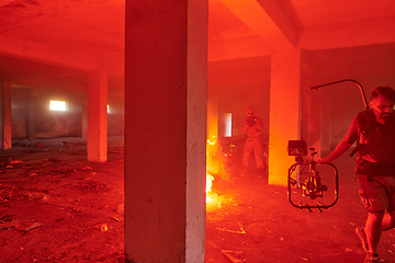 Image showing A professional cameraman captures the intense moments as a group of skilled soldiers embarks on a dangerous mission inside an abandoned building, their actions filled with suspense and bravery