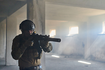 Image showing A professional soldier in an abandoned building shows courage and determination in a war campaign