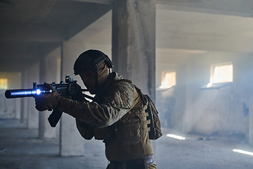 Image showing A professional soldier in an abandoned building shows courage and determination in a war campaign