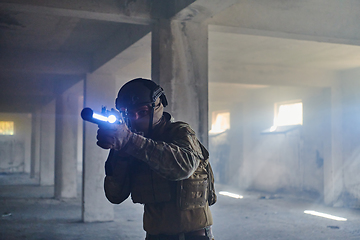Image showing A professional soldier in an abandoned building shows courage and determination in a war campaign