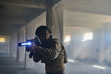 Image showing A professional soldier in an abandoned building shows courage and determination in a war campaign