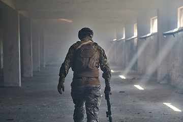 Image showing A professional soldier in an abandoned building shows courage and determination in a war campaign