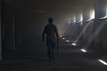 Image showing A professional soldier in an abandoned building shows courage and determination in a war campaign