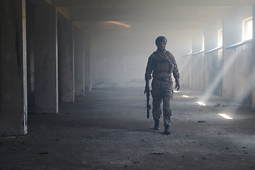 Image showing A professional soldier in an abandoned building shows courage and determination in a war campaign