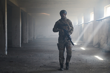 Image showing A professional soldier in an abandoned building shows courage and determination in a war campaign