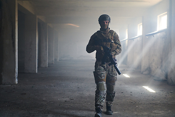 Image showing A professional soldier in an abandoned building shows courage and determination in a war campaign