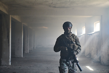 Image showing A professional soldier in an abandoned building shows courage and determination in a war campaign