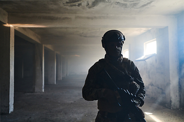 Image showing A professional soldier in an abandoned building shows courage and determination in a war campaign