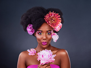 Image showing I just cant help but to love flowers. Studio shot of a beautiful young woman posing with flowers in her hair.