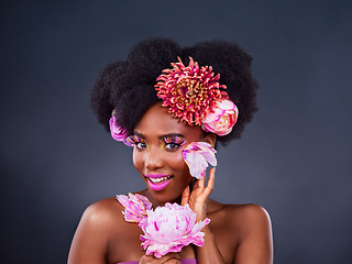 Image showing Forget neutral, add a pop of colour. Studio shot of a beautiful young woman posing with flowers in her hair.