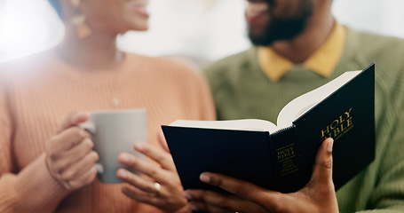 Image showing Closeup, hands and a couple reading the bible together in the morning for spiritual wellness. House, support and a man and woman with coffee, talking and a book for religion education and studying