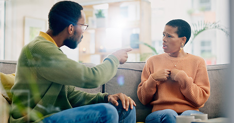 Image showing Fight, couple and home with marriage problem, frustrated and angry man on a living room sofa. Mistake, yelling and conversation of people with argument, fail and conflict with divorce discussion