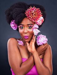 Image showing Everyone is talking about how good I look. Studio shot of a beautiful young woman posing with flowers in her hair.