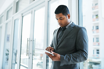 Image showing The best device for those on demand tasks. a young businessman using a digital tablet in a modern office.