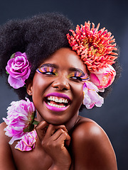 Image showing Flowers have many powers beyond beauty and emotions. Studio shot of a beautiful young woman posing with flowers in her hair.