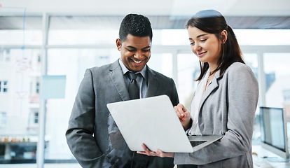 Image showing Leave the desks behind in last century. a young businessman and businesswoman using a laptop in a modern office.